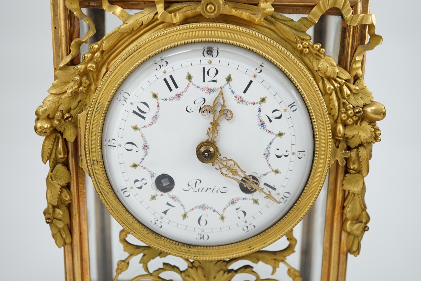 Revel à Paris. A 19th century French ormolu and rouge marble clock garniture